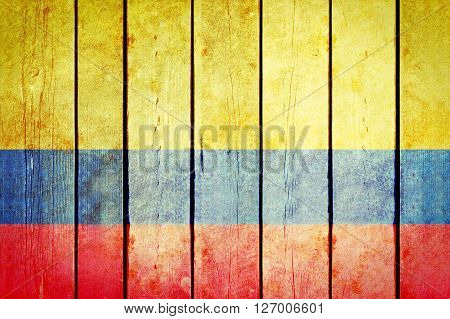 Colombian wooden grunge flag. Colombian flag painted on the old wooden planks. Vintage retro picture from my collection of flags.