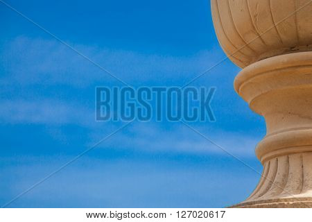 An ancient vase over a blue spring sky