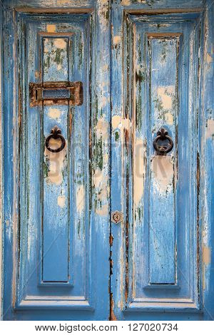Blue weathered door with door knob and letter box