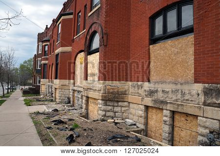 JOLIET, ILLINOIS / UNITED STATES - APRIL 19, 2015: The historic Swinbank Terrace, built in 1890 as Romanesque-style row housing, sits abandoned on Hickory Street in Joliet.