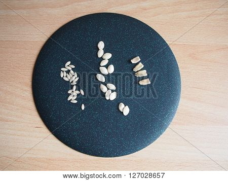 seeds of three types of vegetable cultures against a dark background