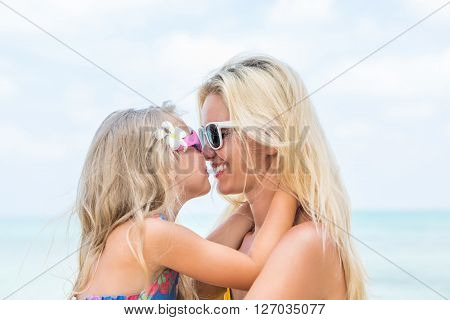 Cute Girl And Beautiful Mother On The Beach