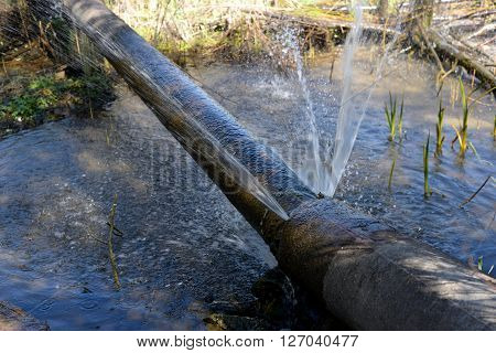Water jet escaping from a broken pipe