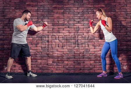 Two figters on the Brick wall background are rady for sparring