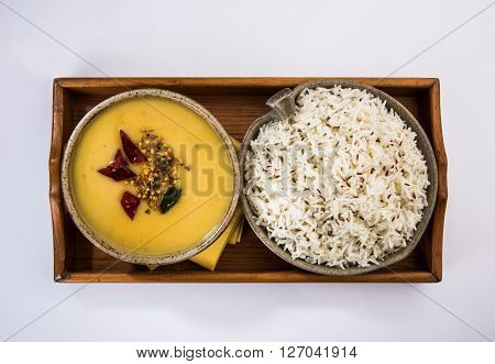 Whole Yellow Lentil with Rice, dal tadka and jeera rice, Indian Dish, cooked rice and cooked Arhar or Toor dal (Pigeon Pea), served in ceramic bowl