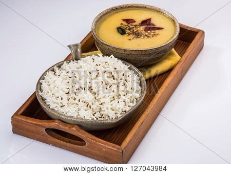 Whole Yellow Lentil with Rice, dal tadka and jeera rice, Indian Dish, cooked rice and cooked Arhar or Toor dal (Pigeon Pea), served in ceramic bowl