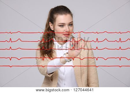 Doctor woman working with cardiogram lines