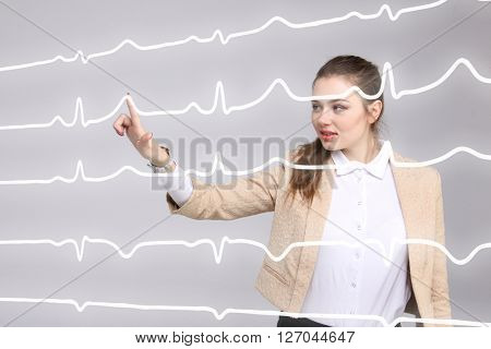 Doctor woman working with cardiogram lines
