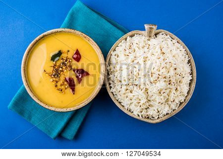 Whole Yellow Lentil with Rice, dal tadka and jeera rice, Indian Dish, cooked rice and cooked Arhar or Toor dal (Pigeon Pea), served in ceramic bowl