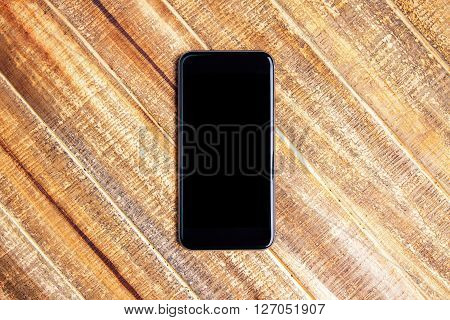 Topview of blank phone on wooden planks. Mock up