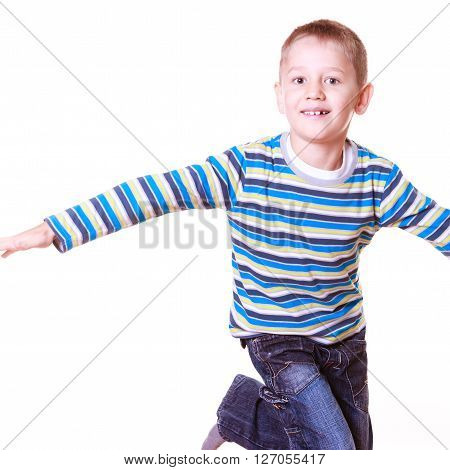 Free time fun and expression. Little boy play alone indoors make silly faces and gestures stand on one leg.