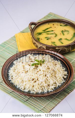 Whole Yellow Lentil with Rice, dal tadka and jeera rice, Indian Dish, cooked rice and cooked Arhar or Toor dal (Pigeon Pea), served in ceramic bowl