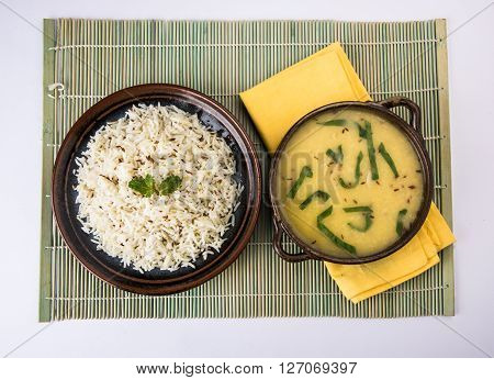 Whole Yellow Lentil with Rice, dal tadka and jeera rice, Indian Dish, cooked rice and cooked Arhar or Toor dal (Pigeon Pea), served in ceramic bowl