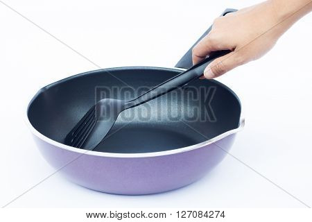 Hand with non stick frying pan on white background, stock photo
