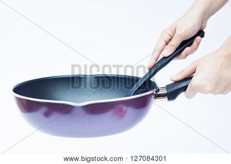 Hand with non stick frying pan on white background, stock photo