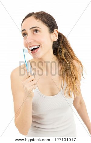 Funny caucasian woman singing with teethbrush in her hand. Isolated on white background.