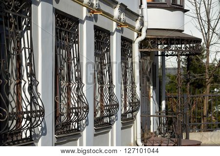 Metal wrought-iron bars on the windows of an apartment house