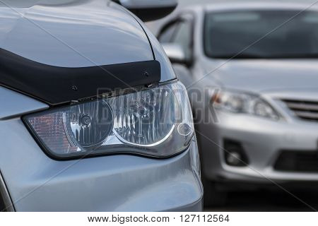 Closeup headlights . Modern luxury car close-up banner background. sports auto Closeup headlights
