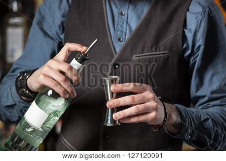 Barman Pouring Alcohol In The Jigger.