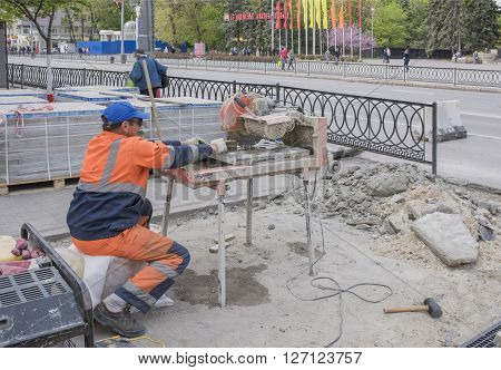 ROSTOV-ON-DON RUSSIA- APRIL 24- Worker cuts paving tiles on the machine tool on April 242016 in Rostov-on-Don