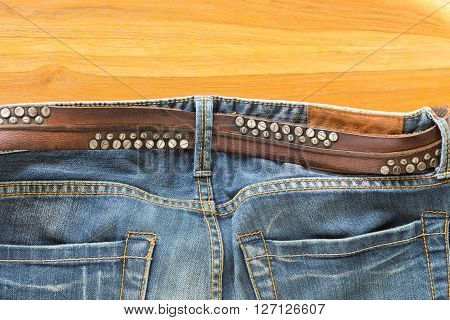 blue jeans with brown leather belt, clothing industry