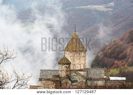 Ancient monastery Tatev covered with clouds in the mountains of Armenia. Was founded in year 906. 