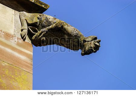 Gargoyle On A Gothic Cathedral, Detail Of A Tower On Blue Sky Background