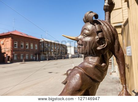 SAMARA RUSSIA - APRIL 24 2016: Fragment of bronze monument fairy-tale characters - Buratino near the museum Aleksei Tolstoi in sunny day