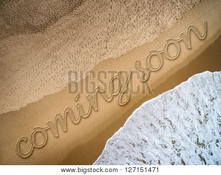 Coming Soon written on the beach