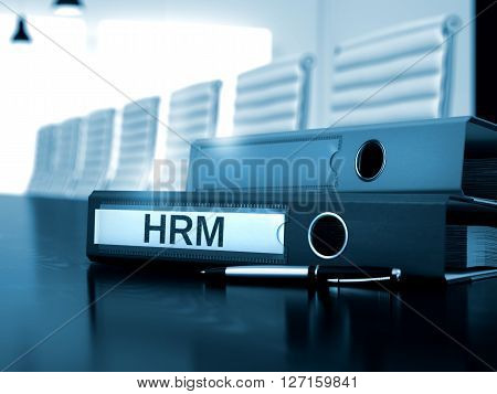 HRM - Illustration. Hrm. Illustration on Blurred Background. HRM - File Folder on Working Desktop. HRM - Business Concept on Blurred Background. 3D Render.