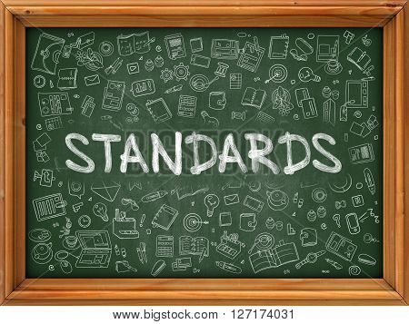 Standards - Handwritten Inscription by Chalk on Green Chalkboard with Doodle Icons Around. Modern Style with Doodle Design Icons. Standards on Background of Green Chalkboard with Wood Border.