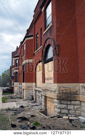 JOLIET, ILLINOIS / UNITED STATES - APRIL 19, 2015: The historic Swinbank Terrace, built in 1890 as Romanesque-style row housing, sits abandoned on Hickory Street in Joliet.