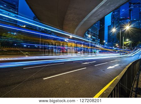 light trails through the footbridge,hongkong china.