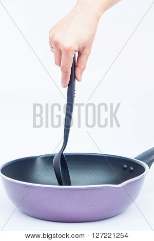 Hand with non stick frying pan on white background, stock photo