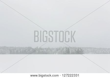Blizzard winter landscape at frozen lake in Finland