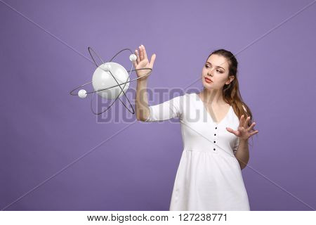 Woman scientist with atom model, research concept