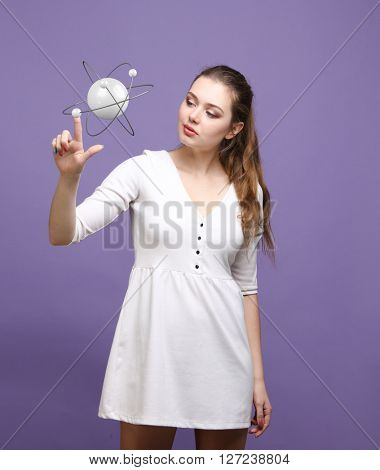 Woman scientist with atom model, research concept