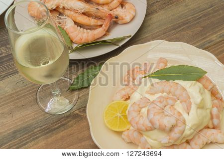 cooked shrimp, prawns with mayonnaise, glass of white wine, bay leaves