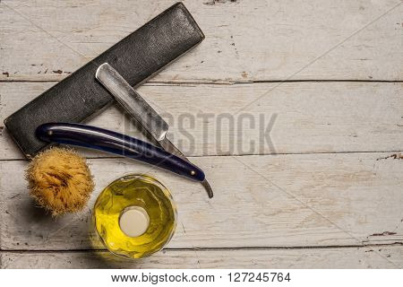 A sharp straight razor brush and cologne aftershave on wooden background
** Note: Soft Focus at 100%, best at smaller sizes