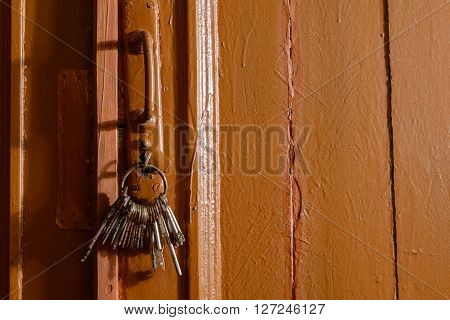 keys in the lock of a old door concept
