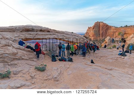 UTAH USA - APRIL 25 2014: people are waiting for a sunrise at Mesa Arch in Canyonlands National Park