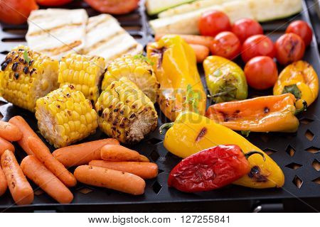 Grilled vegetables, bread and cheese on a grilling pan