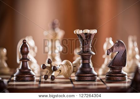 Black chess king crashes white chess king. Competition concept.