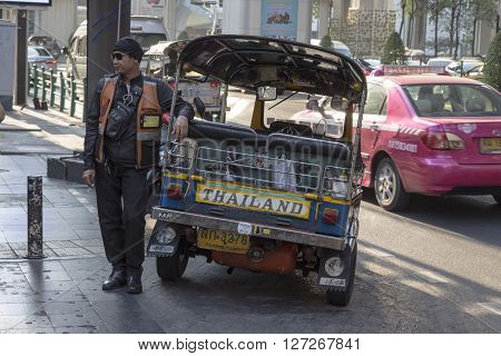 BANGKOK THAILAND - APR 10 : tuktuk is parking on sidewalk of siam square on april 10 2016 thailand. Tuktuk is name of three wheeled taxi car in thailand
