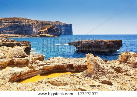 Fantastic views of rocky coast on a sunny day with blue sky. Picturesque and gorgeous scene. Location famous place Azure Window, Gozo island, Dwejra. Malta. Europe. Mediterranean sea. Beauty world.