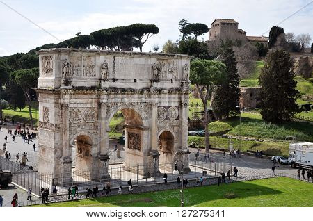ROME ITALY - MARCH 16 2016: Tourist visiting the triumphal Arch of Constantine near the Colosseum in Rome Italy