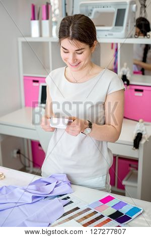 tailors choose the fabric for the dress. Sketches of clothes and fabric samples on the sewing table. the designer is working