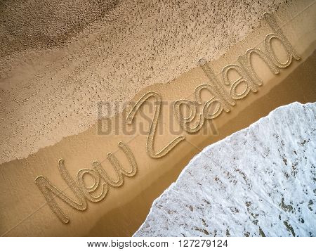 New Zealand written on the beach