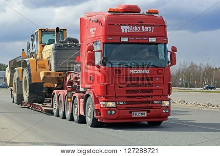 FORSSA, FINLAND - APRIL 23, 2016: Scania 164G transports heavy Volvo L350F wheel loader as wide load in Forssa Finland.