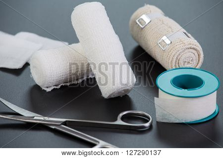 Medical bandages with scissors and sticking plaster